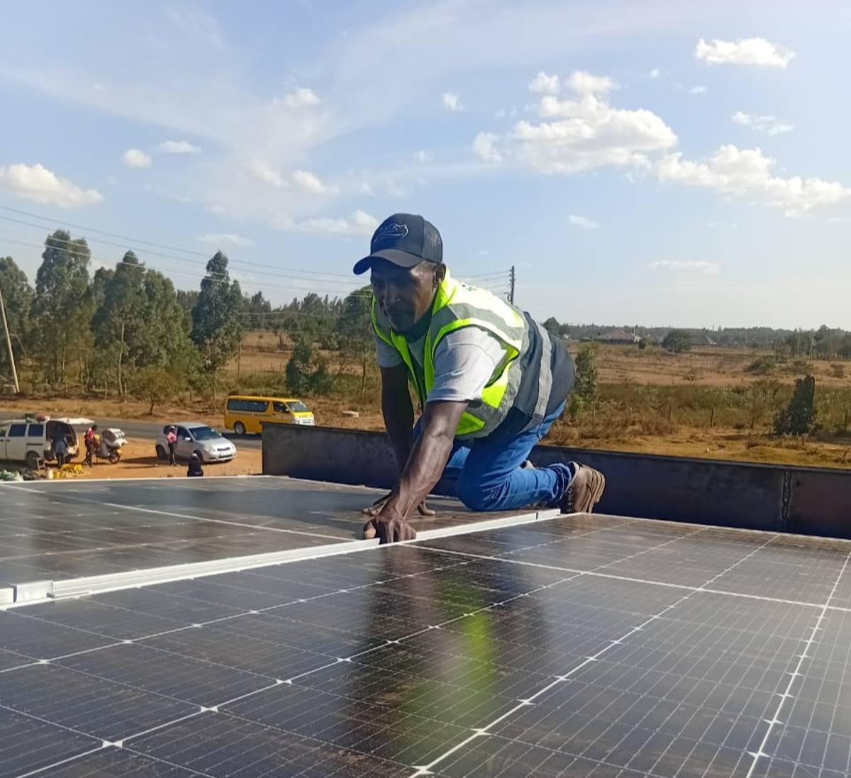 Mintfall technician installing solar panels on a Kenyan rooftop